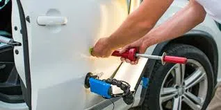Paintless dent repair specialty tools in use