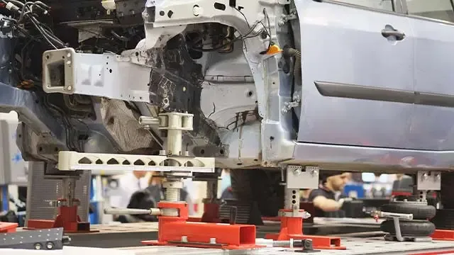 Vehicle on frame straightening machine for structural correction
