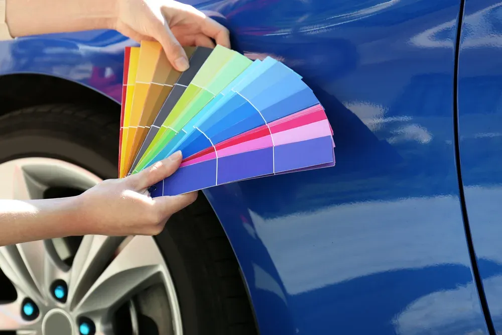 Factory paint color matching swatches against blue vehicle